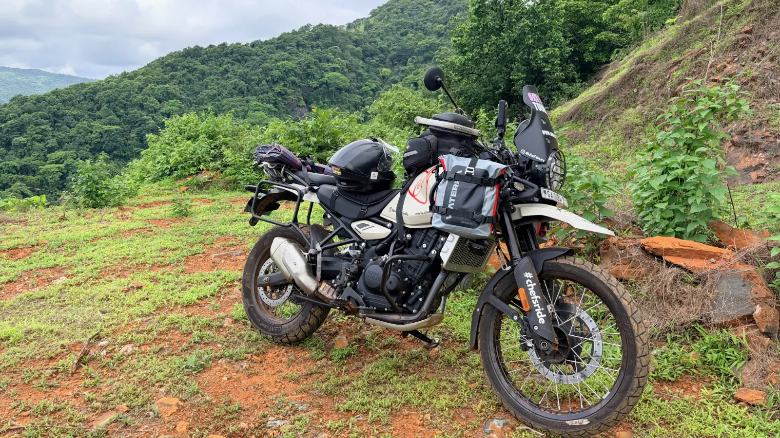 Alan's Royal Enfield Himalayan parked beside a lush hillside during a break in the Western Ghats.