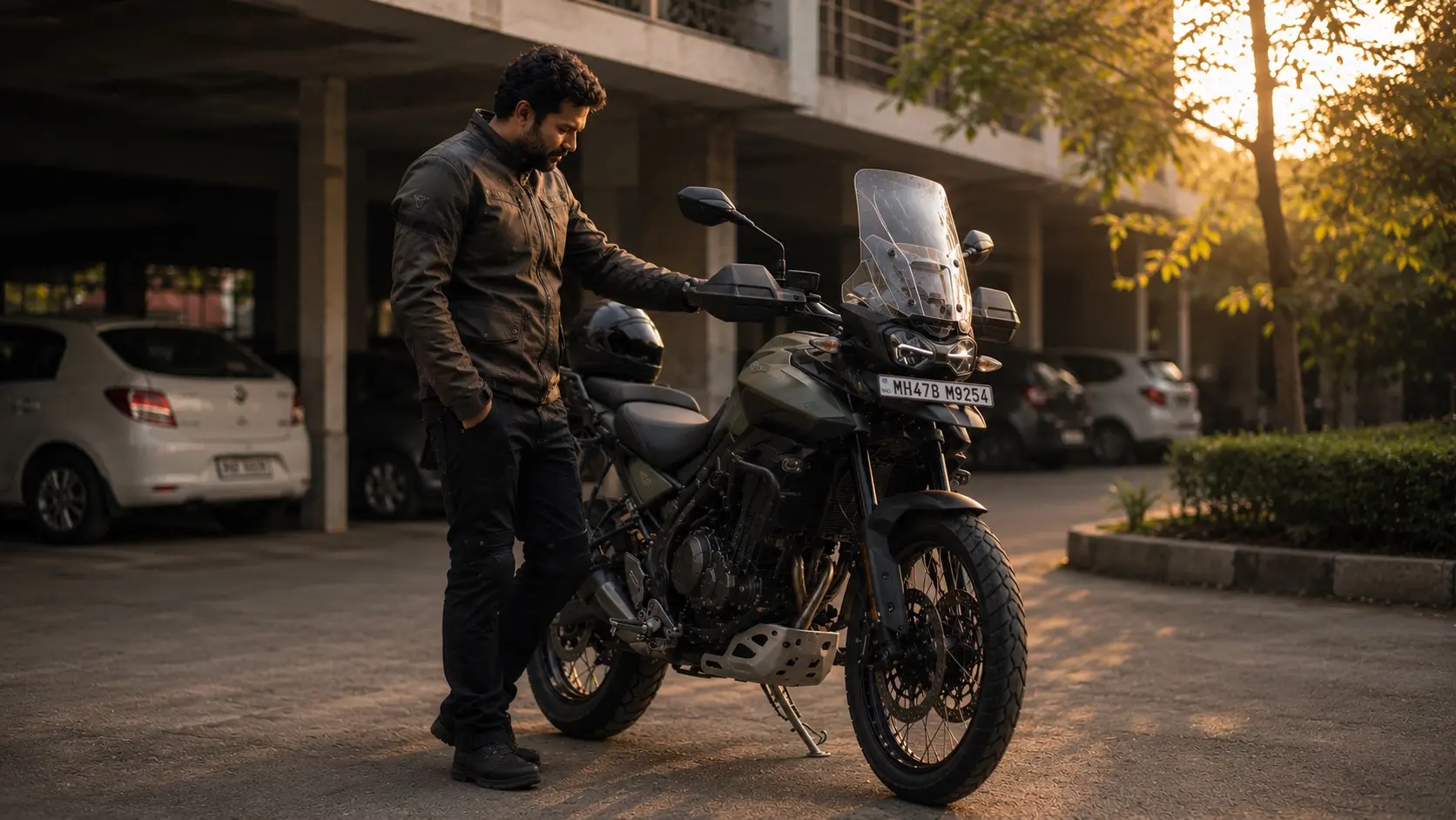 An experienced rider quietly listening to an idling motorcycle after a ride.