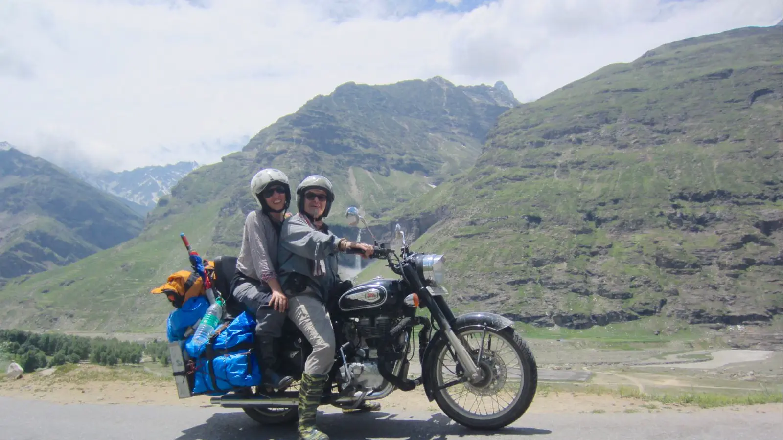 A Royal Enfield Bullet carrying two riders through the Indian Himalayas