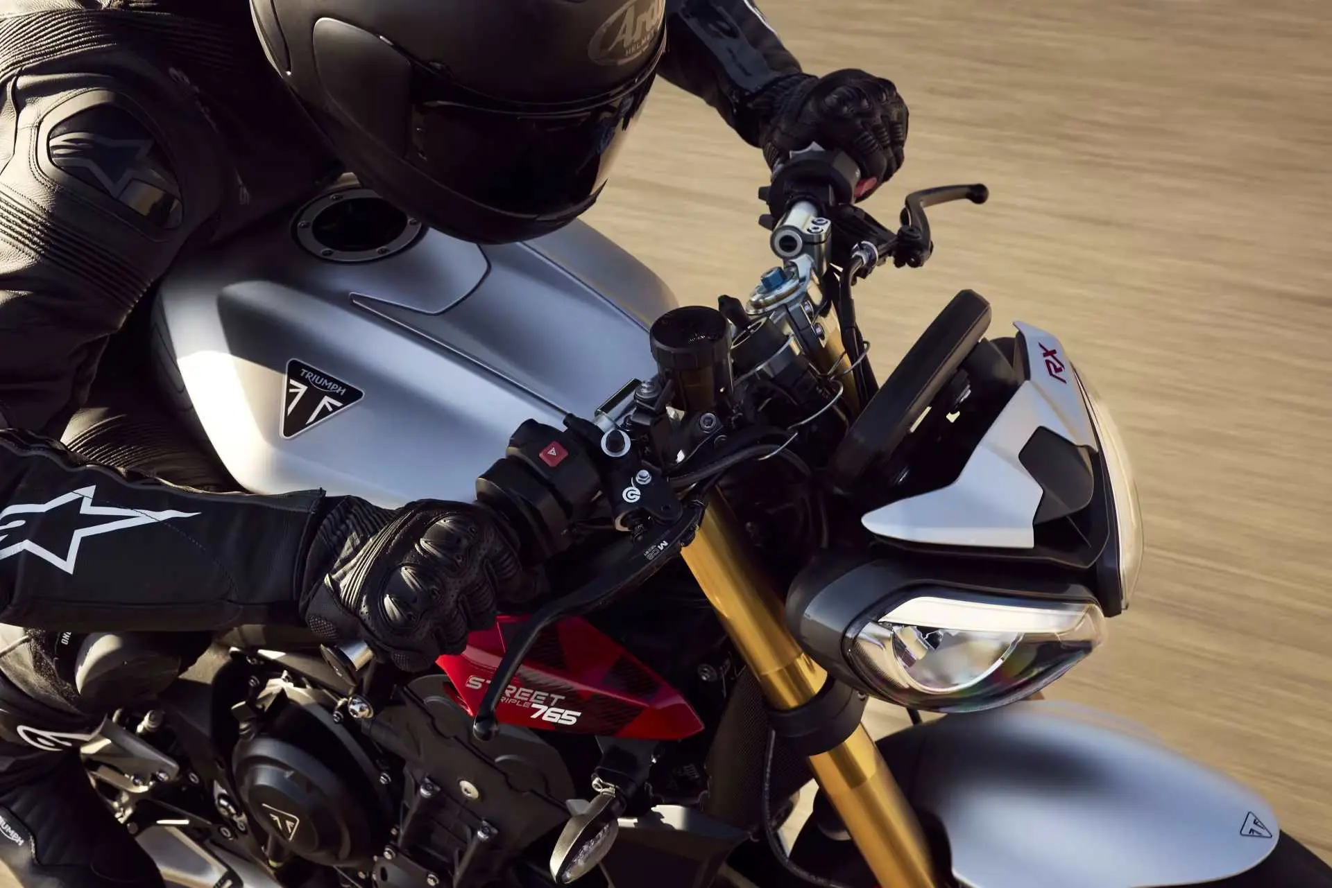 Triumph Street Triple 765 RX parked on racetrack pit lane