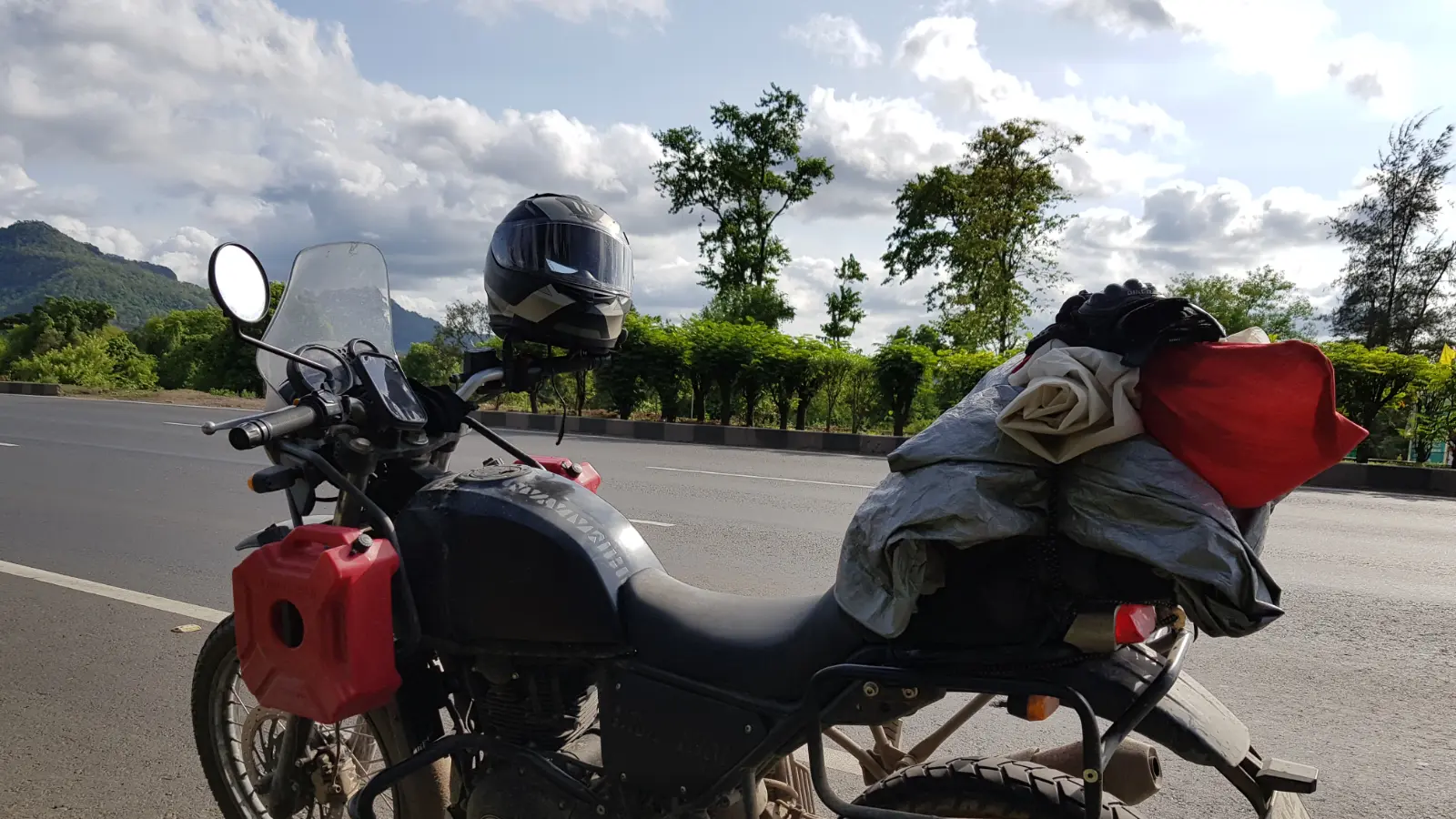 Motorcycle parked beside a mountain road
