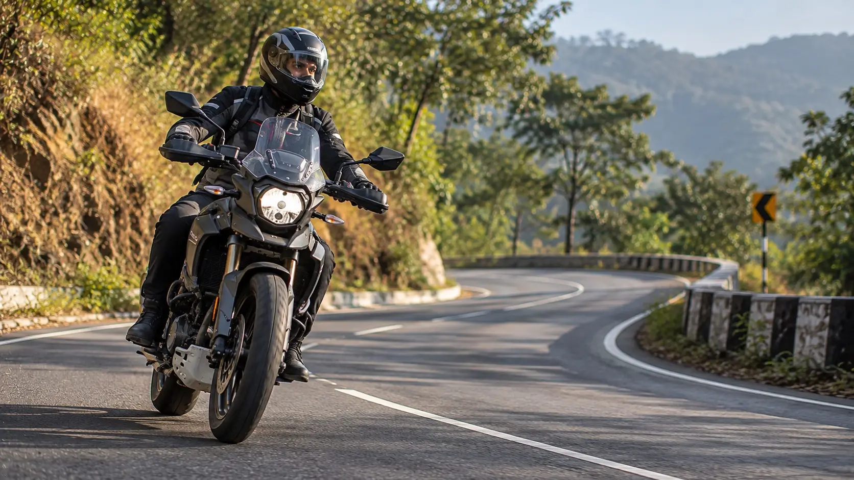 Rider approaching a flowing bend with relaxed posture and progressive braking
