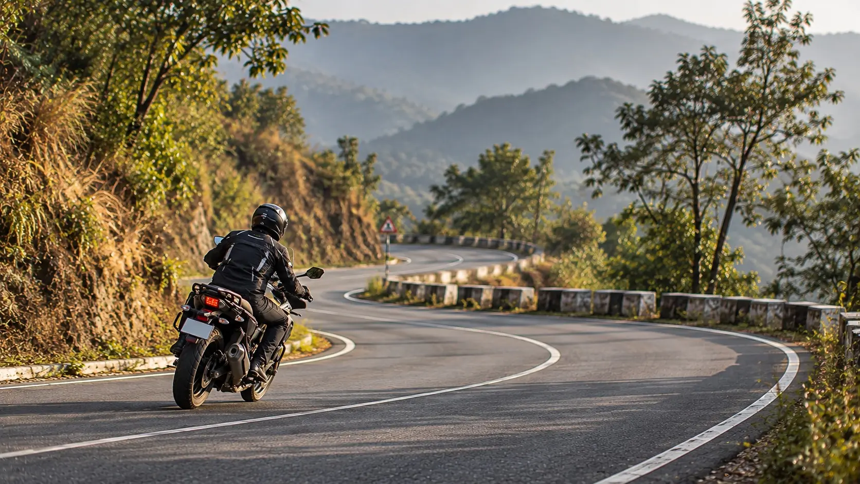 Motorcyclist riding smoothly through a flowing sequence of bends